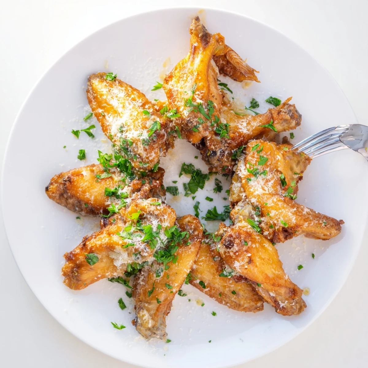 Crispy golden Garlic Parmesan Wings tossed in garlic butter and parsley, served hot on a rustic plate for a savory game day appetizer.