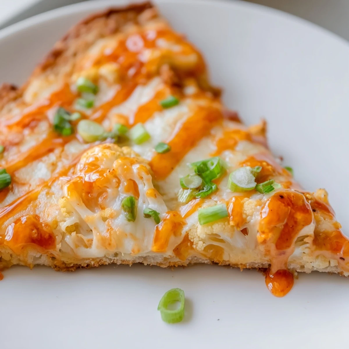 Buffalo Cauliflower Pizza served hot, garnished with green onions and parsley, perfect for a vegetarian dinner.