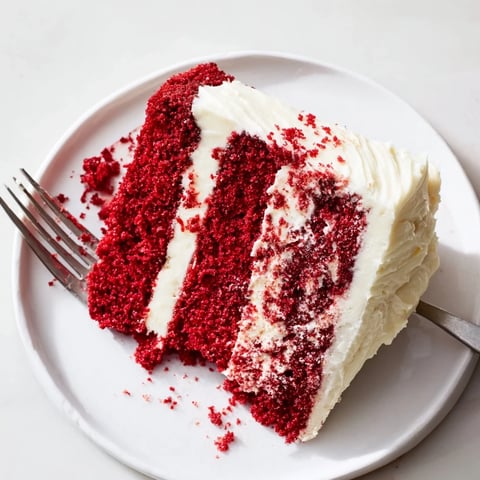 Freshly baked Red Velvet Cake layers with deep crimson red color, ready for assembly and rich cream cheese frosting.