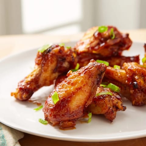 Freshly tossed Honey BBQ Chicken Wings served with blue cheese dip and celery.